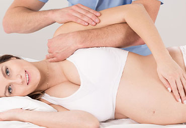 Pregnant woman getting chiropractic adjustment